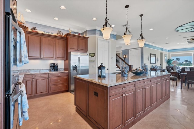 kitchen with pendant lighting, light stone counters, a center island, stainless steel fridge with ice dispenser, and ornamental molding