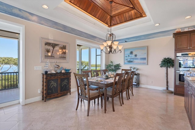 dining area featuring a raised ceiling, crown molding, a chandelier, and wooden ceiling