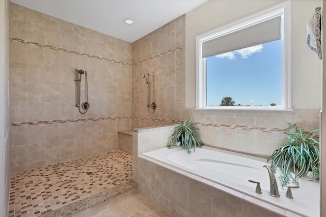 bathroom with shower with separate bathtub and tile patterned flooring