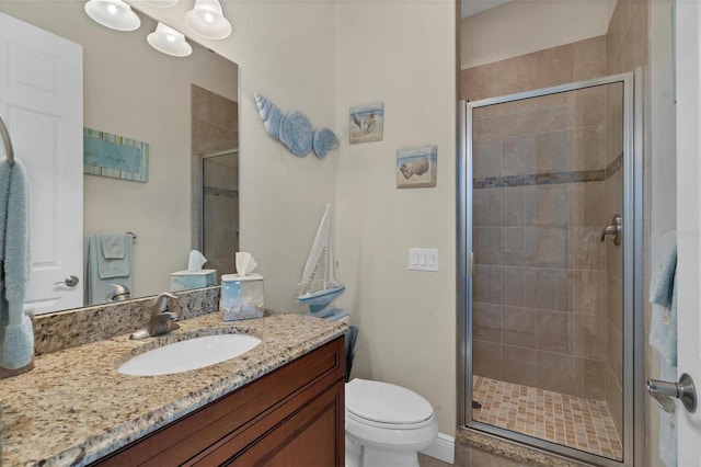 bathroom featuring vanity, toilet, and an enclosed shower