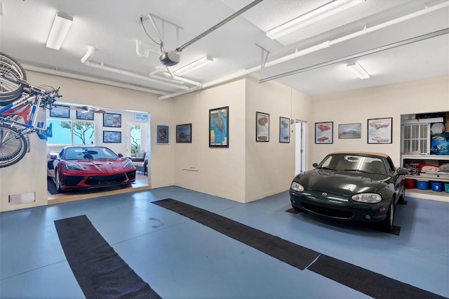 garage with a garage door opener and ceiling fan