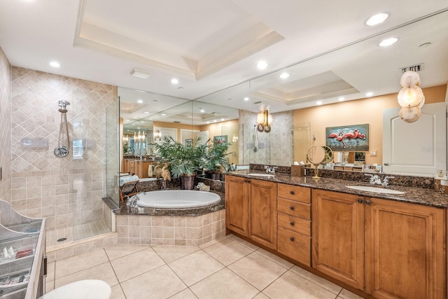 bathroom featuring shower with separate bathtub, tile patterned flooring, a raised ceiling, and vanity