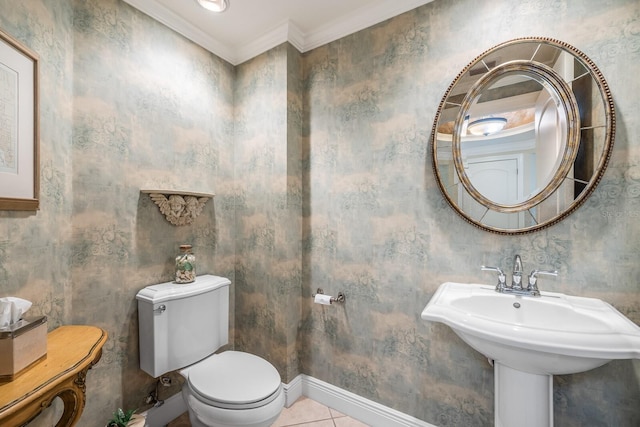 bathroom featuring crown molding, tile patterned flooring, toilet, and sink