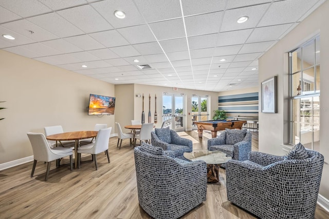 living room with french doors, light hardwood / wood-style flooring, a paneled ceiling, and pool table