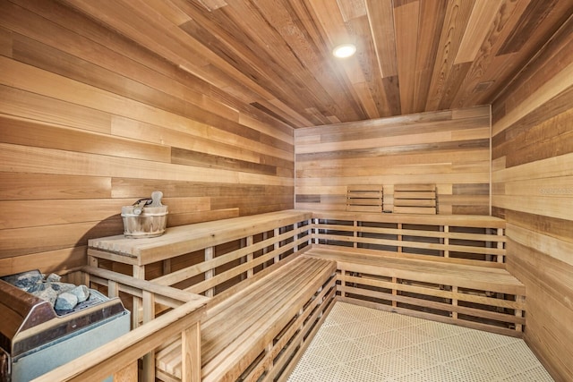 view of sauna / steam room featuring wooden walls and wooden ceiling