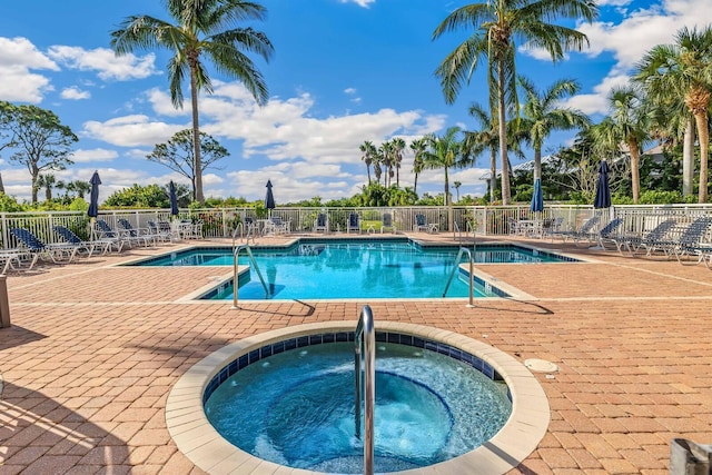 view of swimming pool with a patio area and a community hot tub