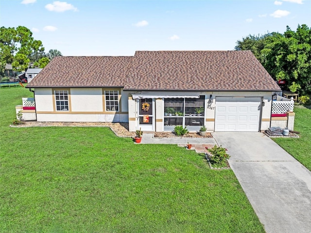 view of front of house with a front yard and a garage