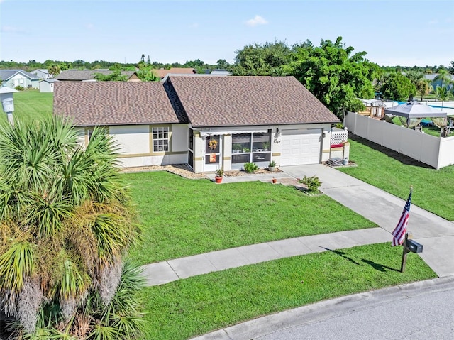 view of front of property with a garage and a front lawn