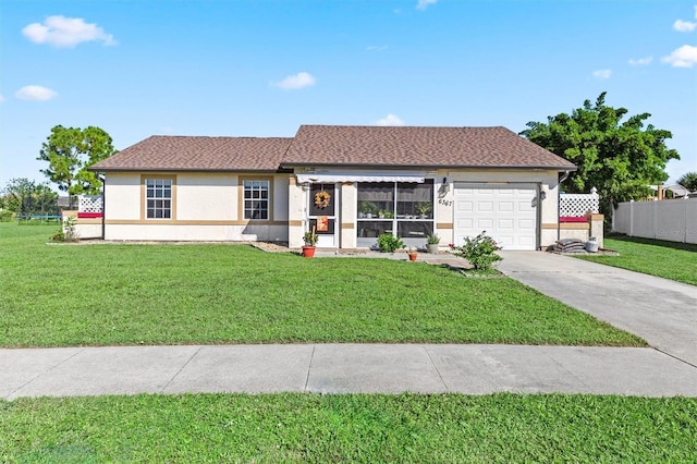 ranch-style house with an attached garage, fence, concrete driveway, stucco siding, and a front yard