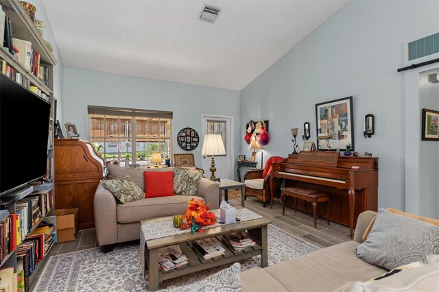 living room featuring lofted ceiling