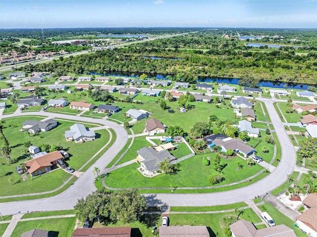 bird's eye view featuring a water view and a residential view