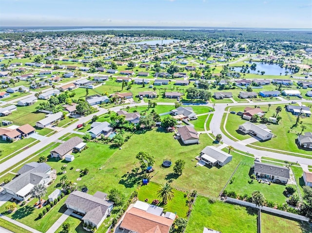 bird's eye view featuring a water view and a residential view