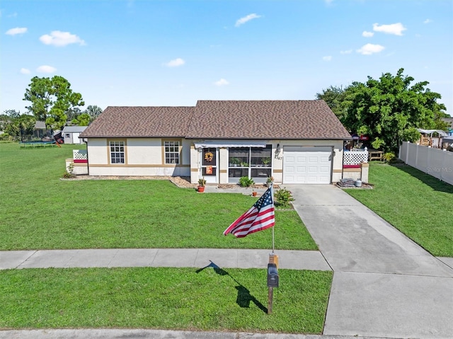 single story home featuring a garage, a front yard, concrete driveway, and stucco siding