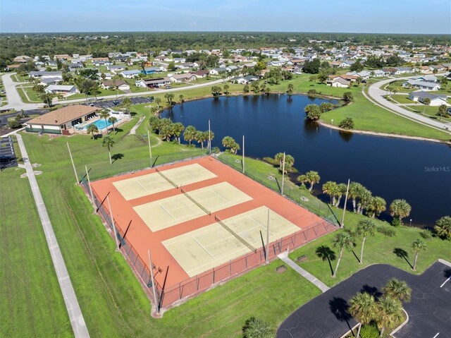 drone / aerial view with a water view and a residential view