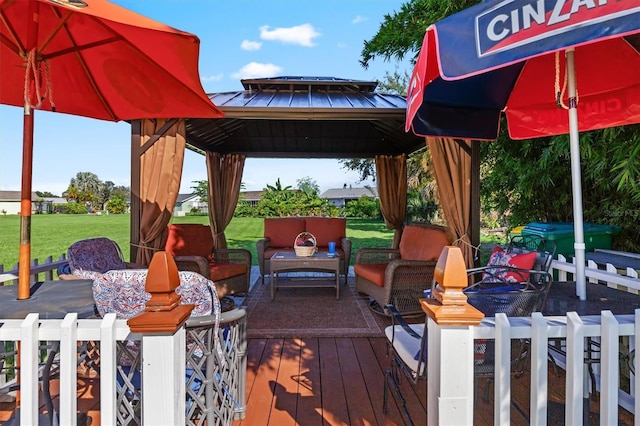 deck featuring a gazebo, a yard, and an outdoor living space