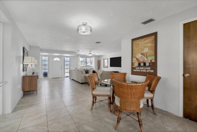 tiled dining room with ceiling fan