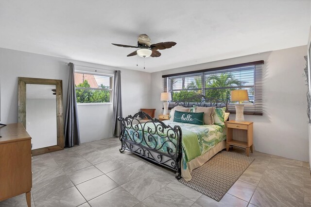 bedroom with multiple windows and ceiling fan