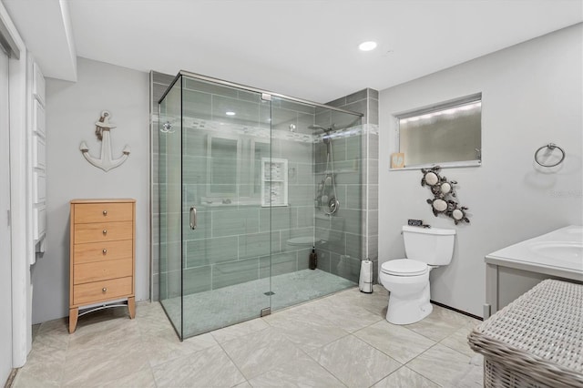 bathroom with vanity, toilet, and a shower with shower door