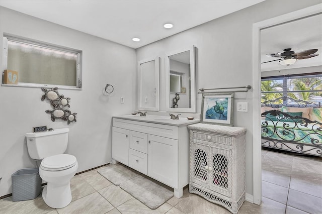 bathroom featuring tile patterned floors, ceiling fan, vanity, and toilet