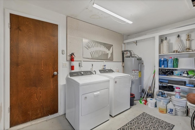 laundry room featuring washing machine and dryer and water heater