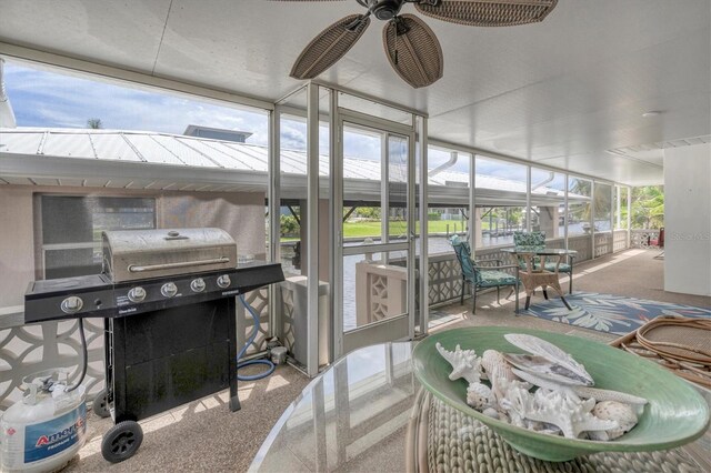 sunroom / solarium featuring ceiling fan and a wealth of natural light