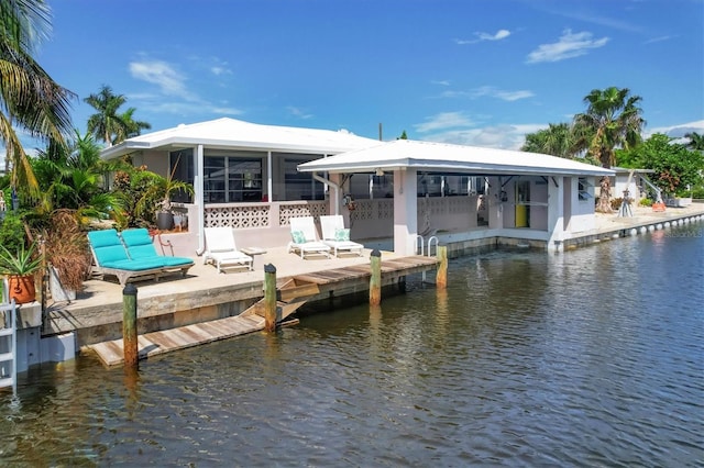 view of dock with a water view and a patio