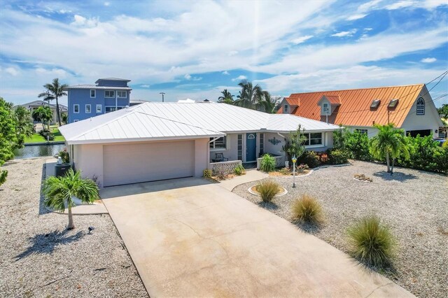 view of front of home featuring a water view and a garage