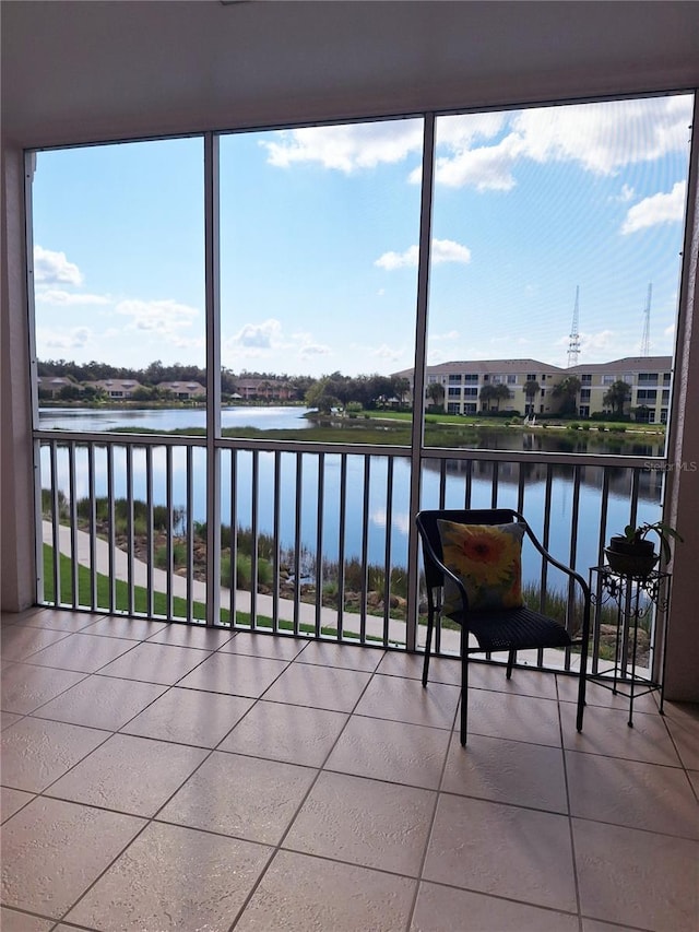 sunroom featuring a water view and plenty of natural light