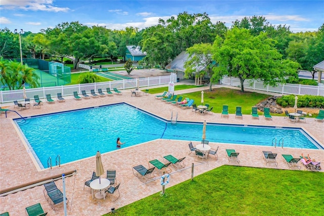 view of swimming pool featuring a patio area and a lawn