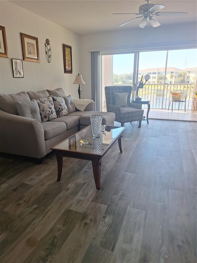 living room featuring hardwood / wood-style floors and ceiling fan