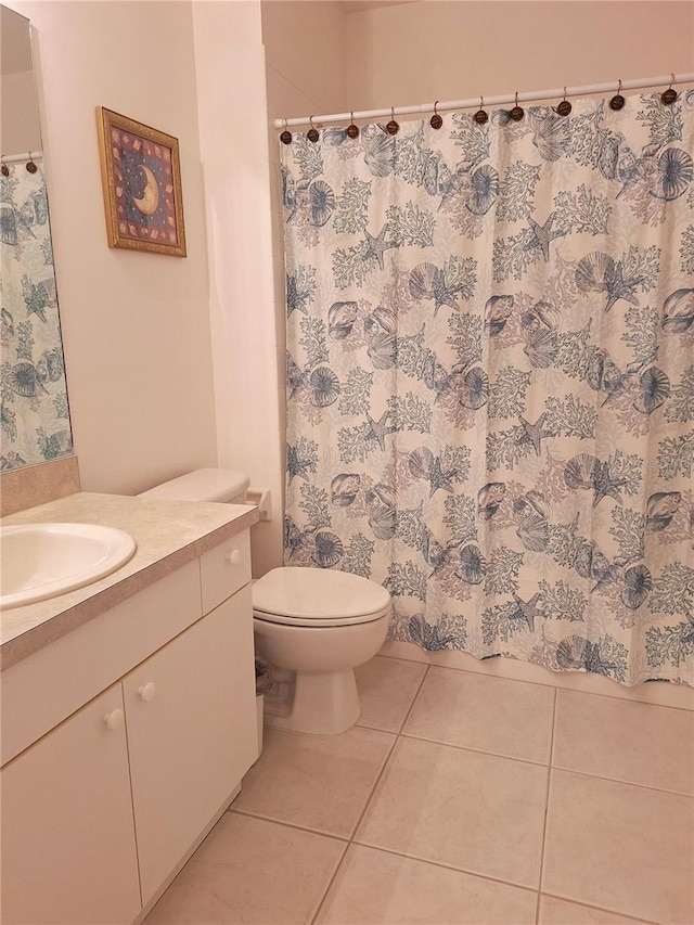 bathroom featuring tile patterned flooring, vanity, and toilet