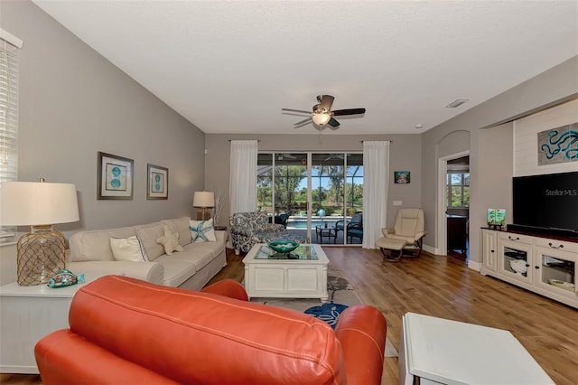 living room with wood-type flooring and ceiling fan