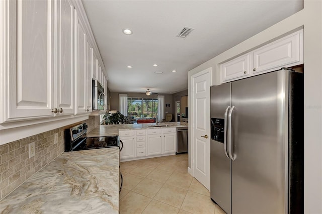 kitchen featuring white cabinets, stainless steel appliances, and sink