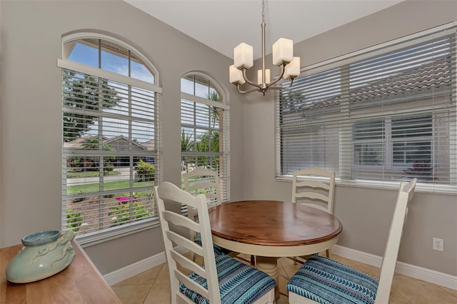 dining room featuring an inviting chandelier and light tile patterned floors