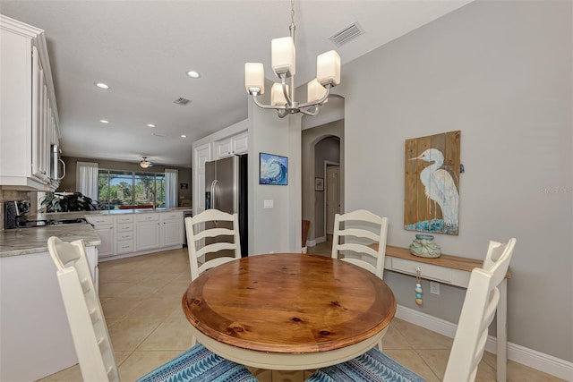 dining area featuring ceiling fan with notable chandelier and light tile patterned flooring