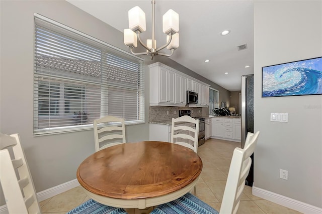 dining space with an inviting chandelier and light tile patterned floors