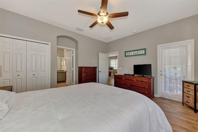 bedroom with ceiling fan, light hardwood / wood-style flooring, and a closet