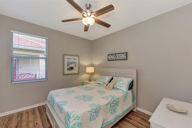 bedroom with wood-type flooring and ceiling fan