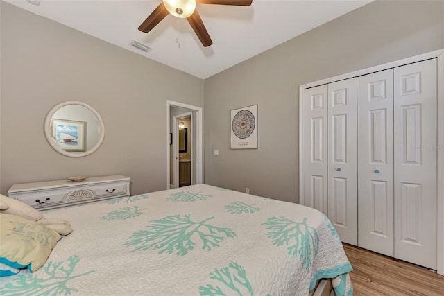 bedroom with light hardwood / wood-style flooring, a closet, and ceiling fan