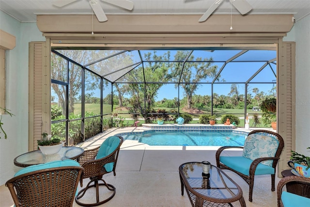 view of pool with a lanai, ceiling fan, and a patio area