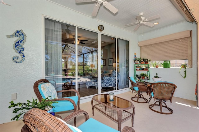 sunroom / solarium featuring ceiling fan and plenty of natural light