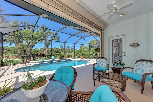 view of swimming pool with a patio, glass enclosure, and ceiling fan