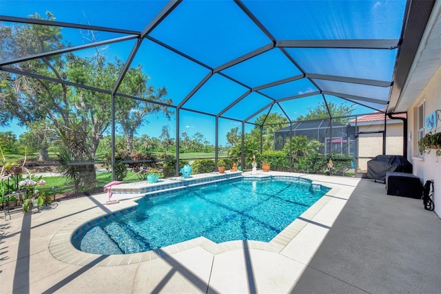 view of pool featuring a patio and glass enclosure