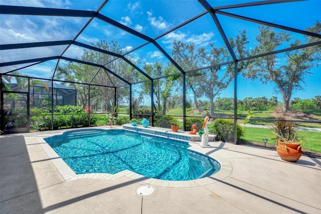 view of pool with a patio and glass enclosure