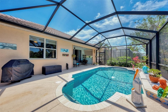 view of pool featuring a patio, grilling area, and glass enclosure