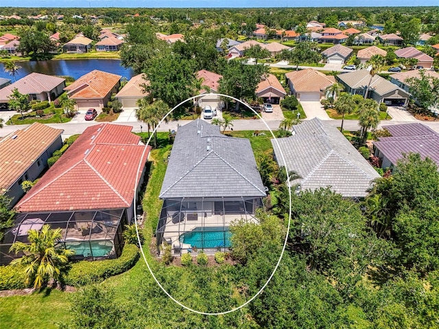 bird's eye view featuring a water view and a residential view