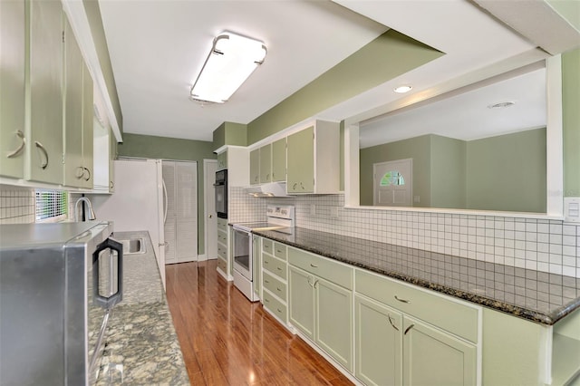 kitchen featuring dark stone countertops, hardwood / wood-style flooring, stainless steel electric range, and green cabinets