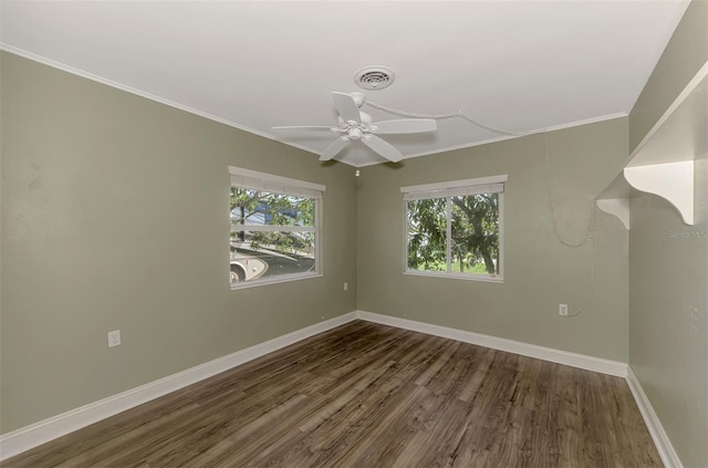 empty room with crown molding, dark wood-type flooring, and ceiling fan