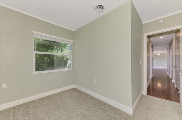 spare room featuring ornamental molding and hardwood / wood-style floors