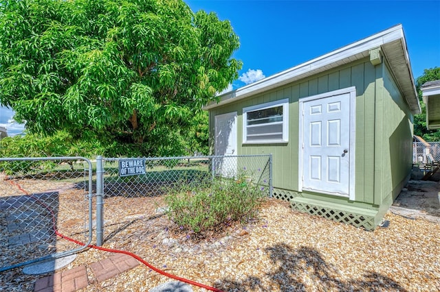 view of property exterior with a storage unit